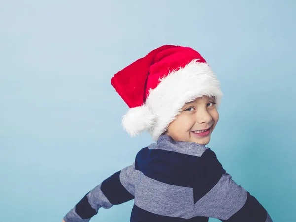 Little Boy Wearing Red Santa Hat Posing Front Blue Studio — Stock Photo, Image