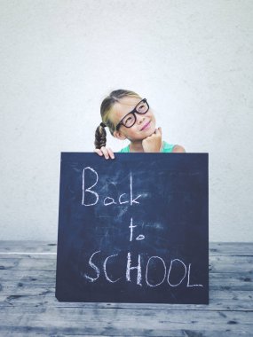 blackboard kelimelerle okula ayak bağı gözlük ile kız 