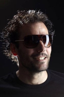 yakışıklı Brunet adam portre stüdyo arka planda gülümsüyor giyen 