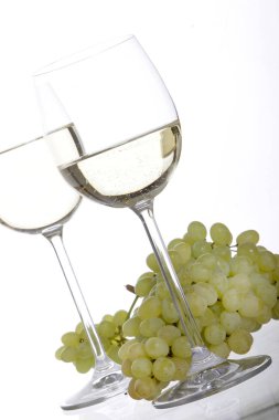 beyaz şarap ve üzüm beyaz zemin üzerine izole iki kadehlerin yakın çekim 