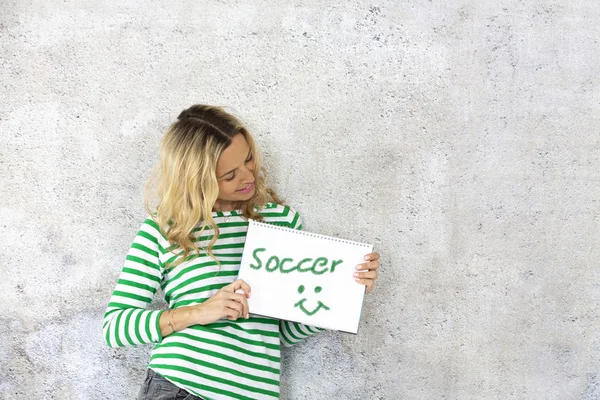 Cute Blonde Woman Striped Pullover Holding Notepad Word Soccer — Stock Photo, Image