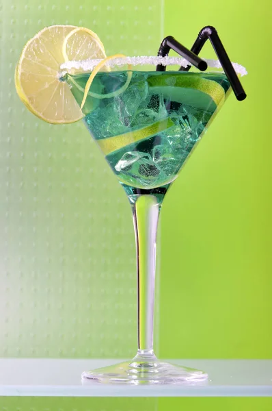 green cocktail in martini glass decorating with lime slice and sugar,close-up