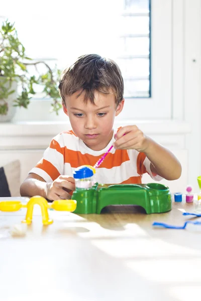 Little Boy Experimenting Colors While Sitting Table Window Home — Stock Photo, Image