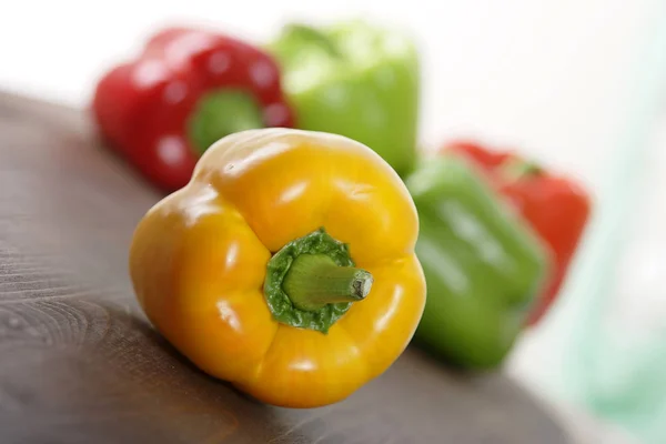 pile of colorful bell peppers on wooden background, close-up