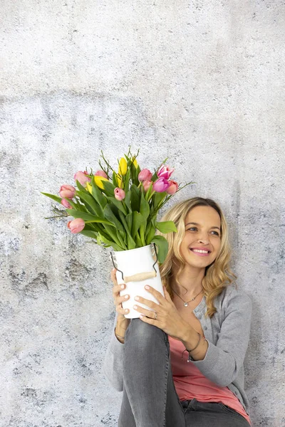 Beautiful Blonde Woman Holding Milk Jug Colorful Tulips Concrete Wall — Stock Photo, Image