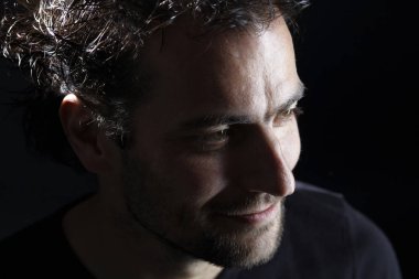 koyu arka planda, yakın çekim görünümlü yakışıklı sakallı Brunet adam portre