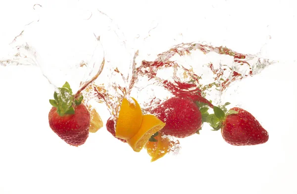 Reife Rote Erdbeeren Mit Orangenscheiben Die Auf Wasser Fallen Nahaufnahme — Stockfoto