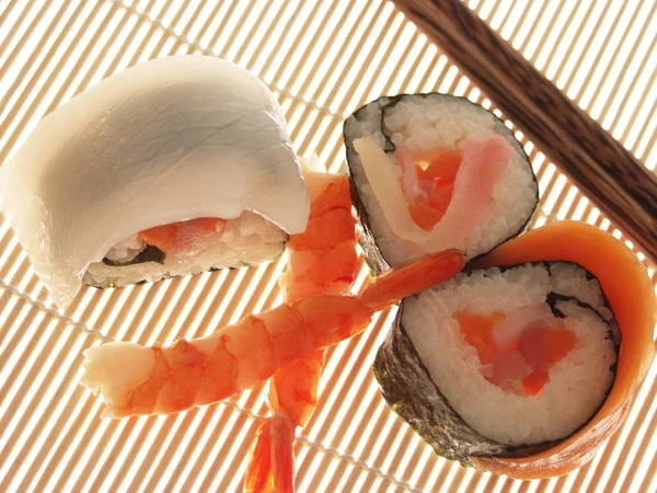 pile of sushi on bamboo mat, close-up
