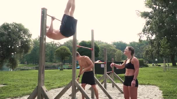 Two Male Athletes Woman Training While Doing Exercises Horizontal Bar — Stock Video