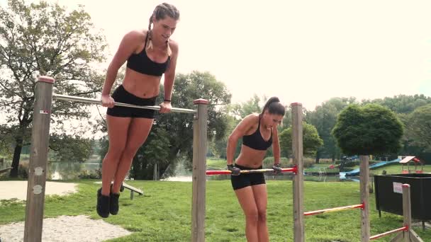 Female Athletes Doing Exercises Horizontal Bars Stadium — Stock Video