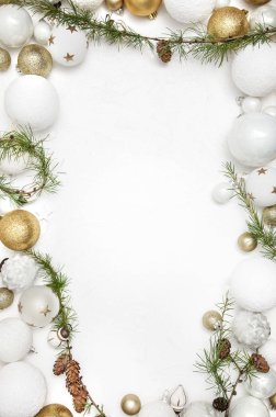 Noel tebrik kartı altın ve beyaz baubles ve çam dalları, koniler ile yakın çekim 