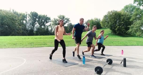 Two Women Two Men Doing Jump Lunges Stadium — Stock Video