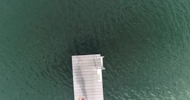 Woman Men Jumping Wooden Pier Water Sunny Day — Stock Video