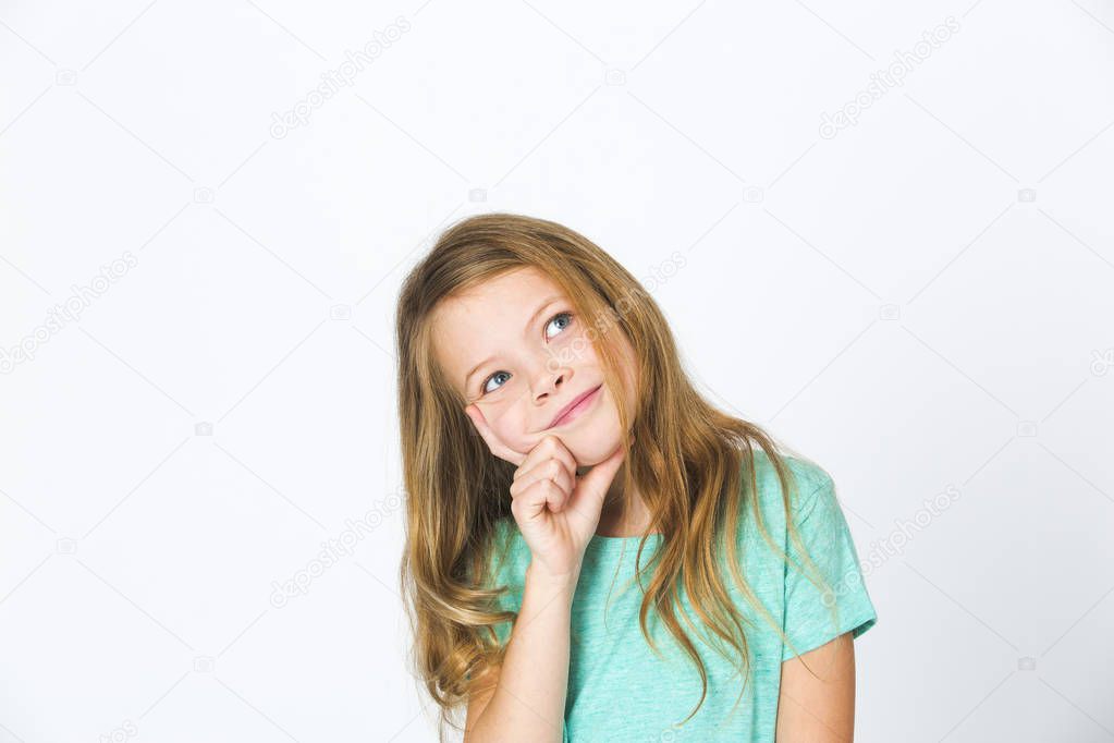 pensive pretty girl in green t-shirt looking aside while posing isolated on white background, close-up 