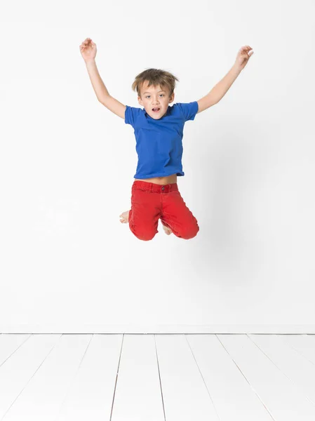 Cute Boy Blue Shirt Red Trousers Jumping High Wooden Floor Royalty Free Stock Photos