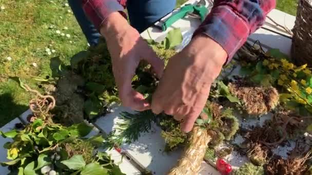 Floristin Fertigt Handgefertigten Blumenkranz Auf Holztisch Garten — Stockvideo