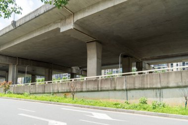 Şehirdeki üst geçidin altında beton yapı ve asfalt yol alanı