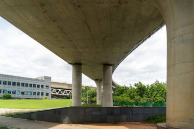Şehirdeki üst geçidin altında beton yapı ve asfalt yol alanı