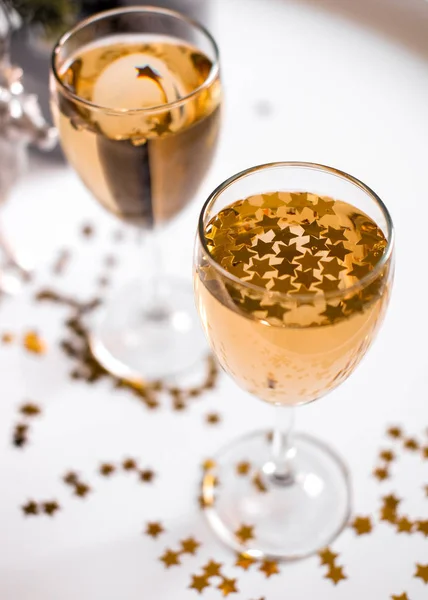 A glass of champagne with golden stars — Stock Photo, Image