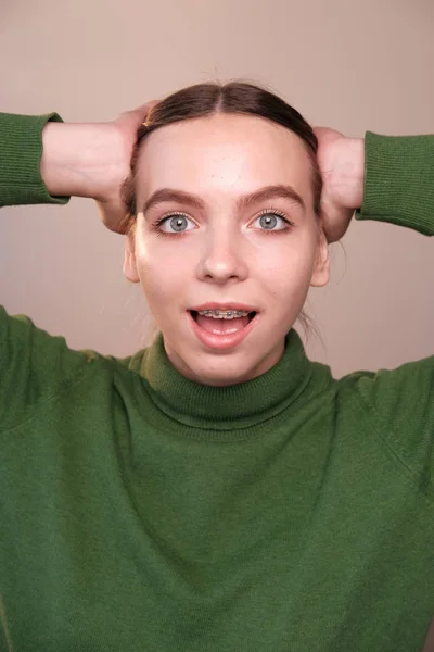 Portrait Excited Young Woman Green Sweater Hands Head — Stock Photo, Image
