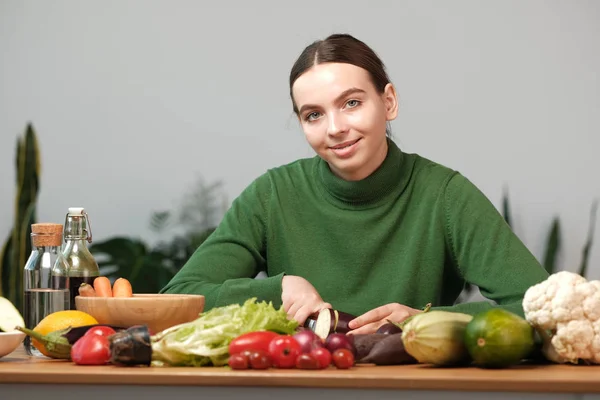 家庭のインテリアで野菜を切る若い女性 — ストック写真