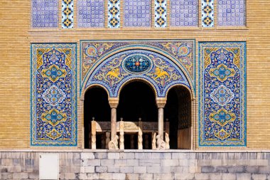 Tile art on the wall of Karim Khani Nook with a small marble throne inside the terrace. Golestan palace, Tehran, Iran. clipart