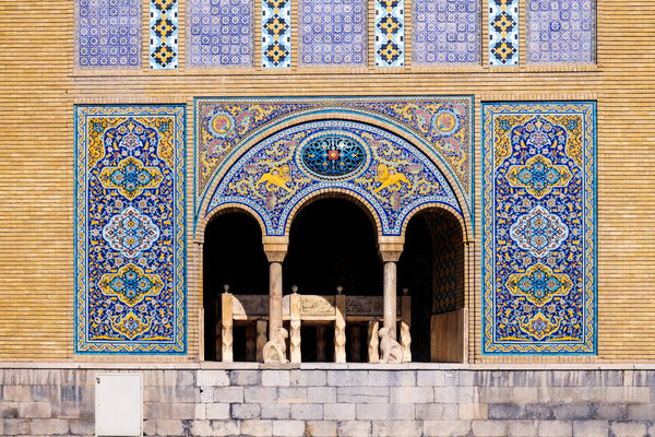 Tile art on the wall of Karim Khani Nook with a small marble throne inside the terrace. Golestan palace, Tehran, Iran.