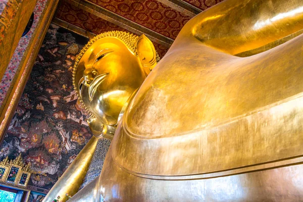Giant golden reclining Buddha statue. Wat Pho temple, Bangkok, Thailand.