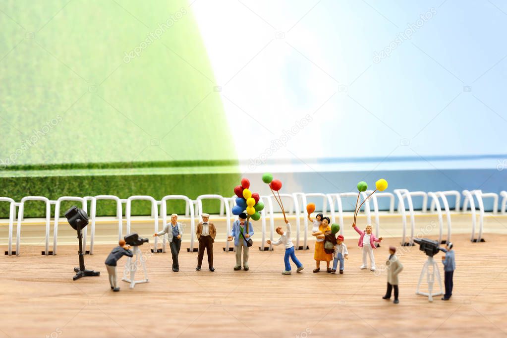 Miniature people : journalists , cameraman ,Videographer at work shooting of the people,using for concept of TV talk Show Host Day.