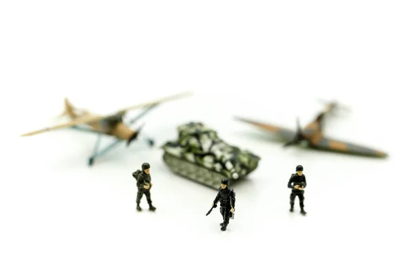 Miniature people : team soldier  standing together with army tank and aircraft air combat using for  War, army, military, guard concept.