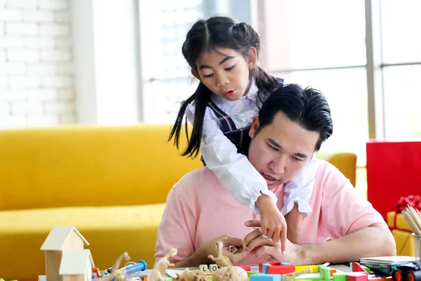 Parent and little child having fun playing educational toys,Family concept.