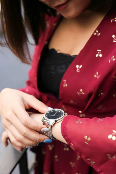 Beautiful woman looking at her watch.