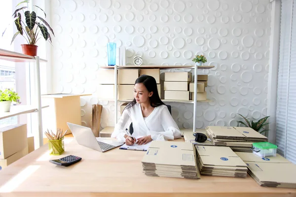 Genç Asyalı kız freelancer başlangıç adresi işyerinde karton kutu üzerinde yazma, alışveriş online küçük iş girişimci KOBİ veya serbest nakliye küçük işletme sahibi kadar olduğunu