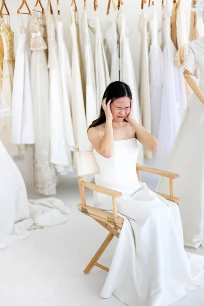 Beautiful angry and agressive shouting bride wearing white dress
