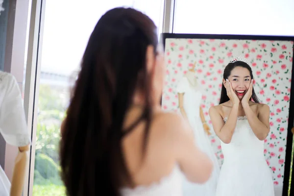 Beautiful bride getting dressed by her best friend in her weddin