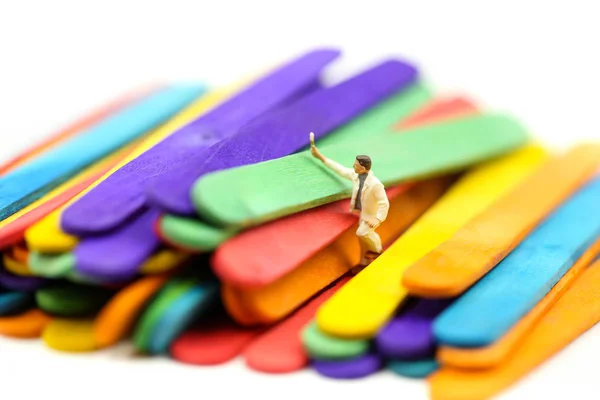 Miniature people : worker painting on Colorful ice cream sticks