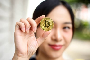 Bitcoin altın c tutan İş kadını ile odak seçici