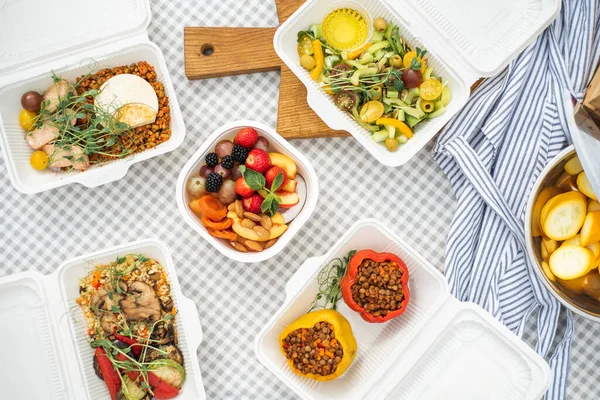 Sat of take away boxes with healthy food on the table. Restaurant dishes. Top view. Flat lay. High quality photo