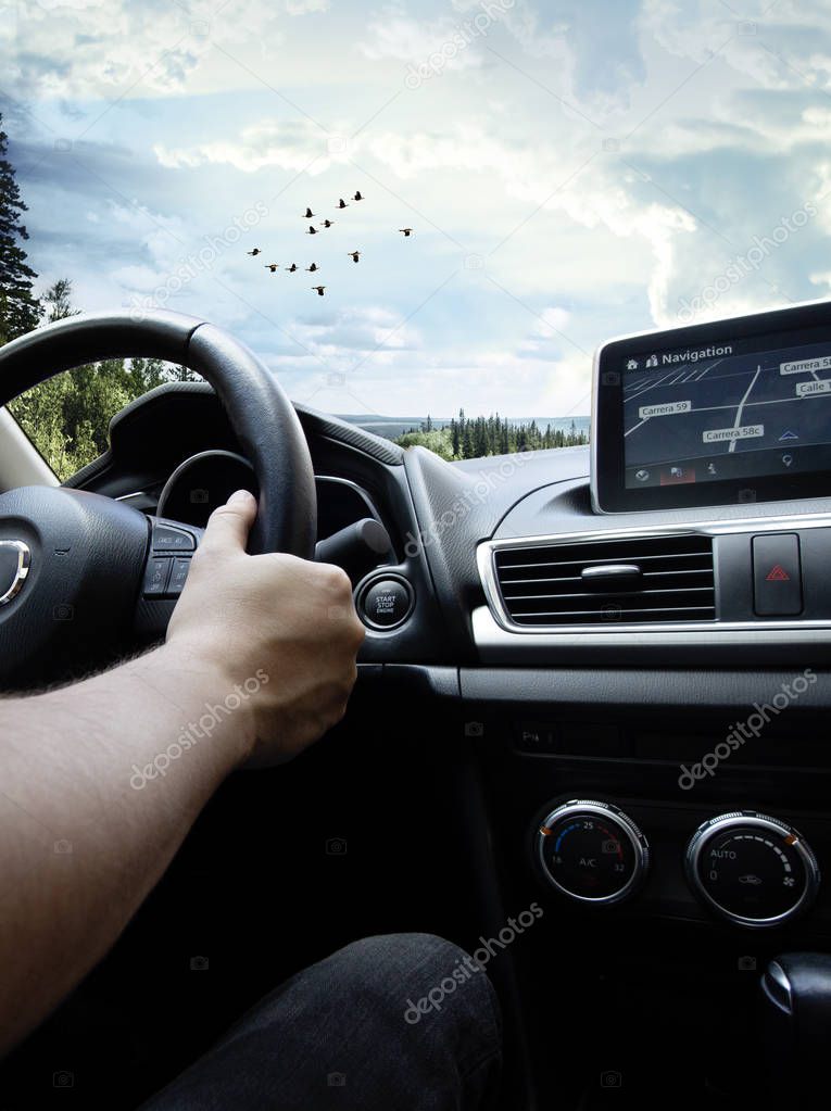 Man driving his car, traveling by road and enjoying the scenery