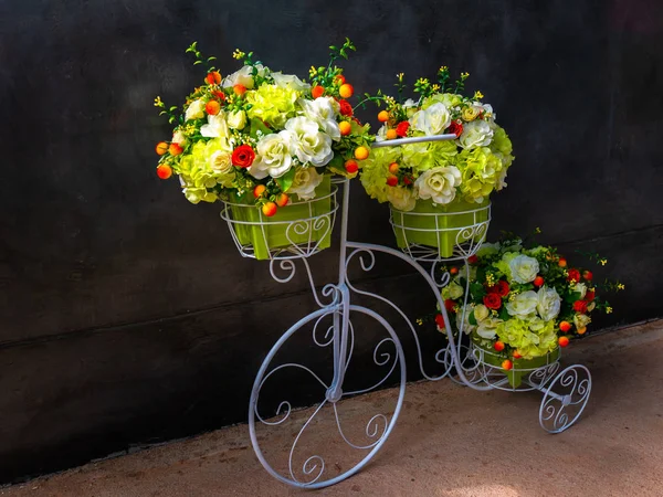 Artificial flowers and  Artificial tricycle, rered white green and yelow flowers
