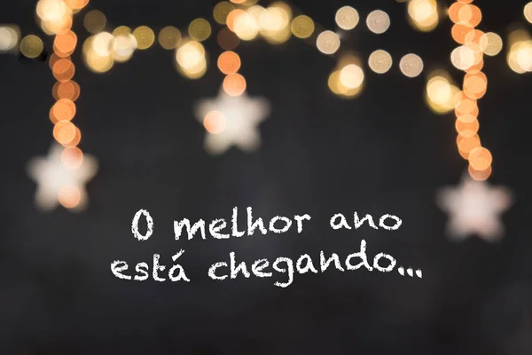o melhor ano esta chegando Portekizce anlamına gelir en iyi yıl bulanık beyaz yıldızlar ve sarı ışık ile siyah arka plan geliyor