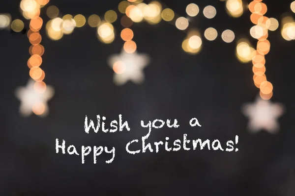 Metin dilek sen a mutlu Noel bulanık yıldız ve ışık ile siyah arka plan