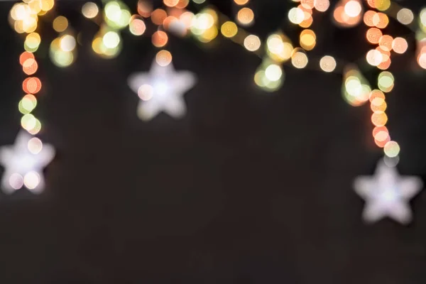 siyah arka plan bulanık renkli yıldız ve bir kartpostal için ışıkları ile