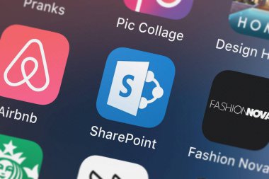 London, United Kingdom - September 29, 2018: Icon of the mobile app Microsoft SharePoint from Microsoft Corporation on an iPhone. clipart