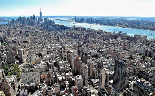View of Manhattan buildings from the Empire State Building, the Hudson river and the New York Harbor.