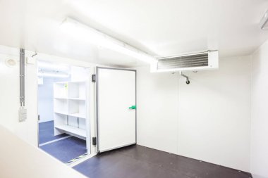 an empty industrial room refrigerator with four fans clipart