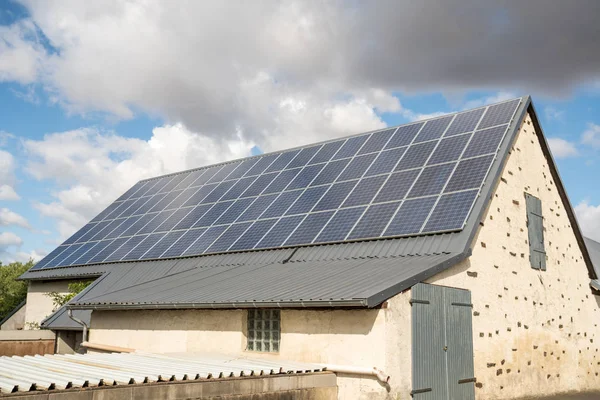 on an building in an residential area, there are solar panels on the roof