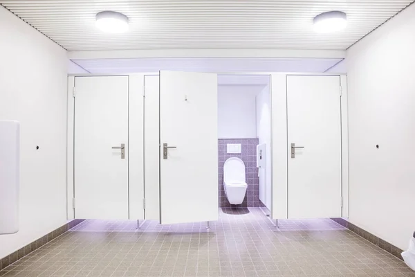 In an public building are womans toilets whit white doors