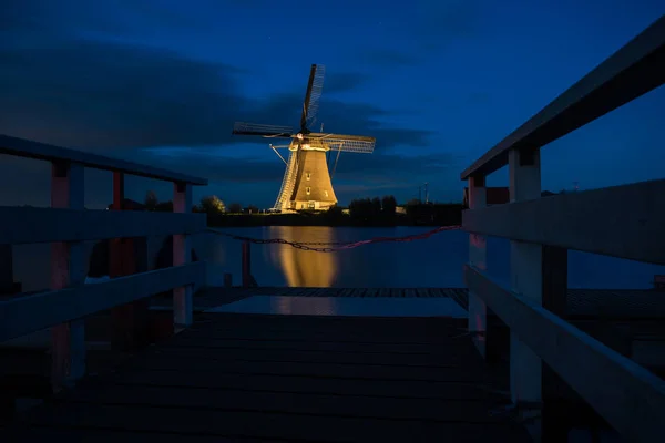 During the blue hour at night in the world famous Kinderdijk in the Netherlands with the windmills illuminated