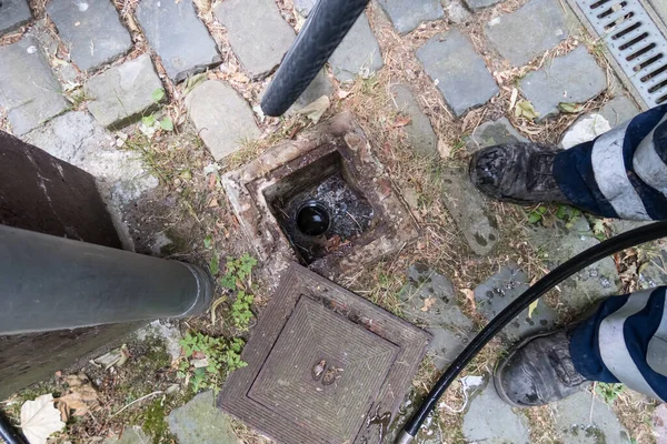 There is a sewer system in the ground that needs to be checked to make sure there are no blockages. — Stock Image Sewer System Ground Needs Checked Make Sure Blockages Stock Photo